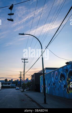 Shoes hanging from a telephone wire at dusk in East Vancouver, BC. Stock Photo