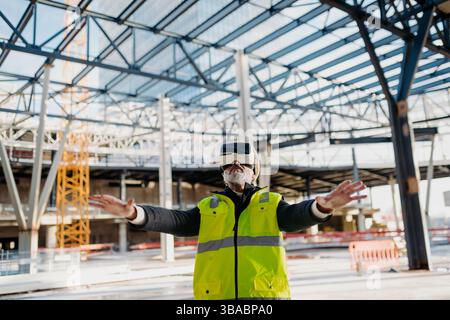 Engineer using virtual reality to inspect building progress. Stock Photo