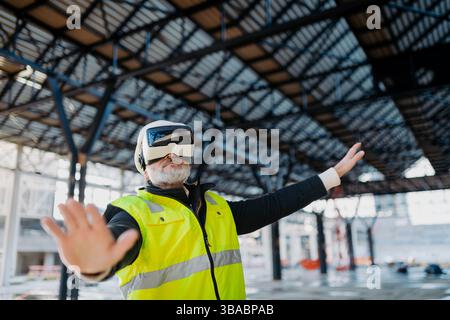 Engineer using virtual reality to inspect building progress. Stock Photo