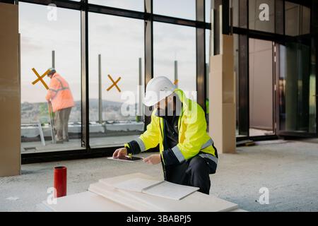 Construction site manager using digital tablet to inspect building progress. Stock Photo