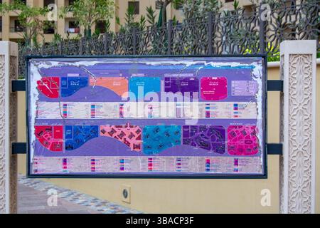 A colorful map display showing various sections and amenities of a residential complex, with labeled areas and a legend for navigation. Stock Photo