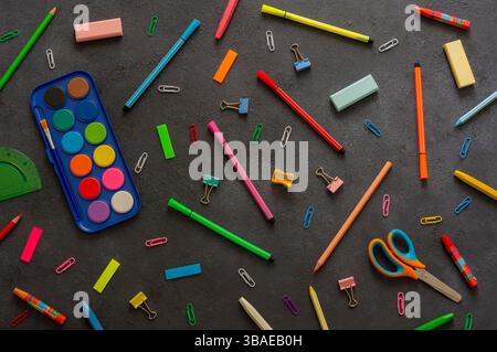 Back to school concept, school supplies and accessories on black background, water color, pencils, duster, crayons, flat lay copy space Stock Photo