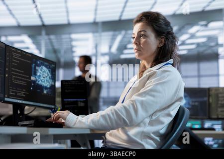 System administrator using artificial intelligence technology to optimize data center performance. Server room expert using AI tech to streamline operations and accurately forecast potential issues Stock Photo