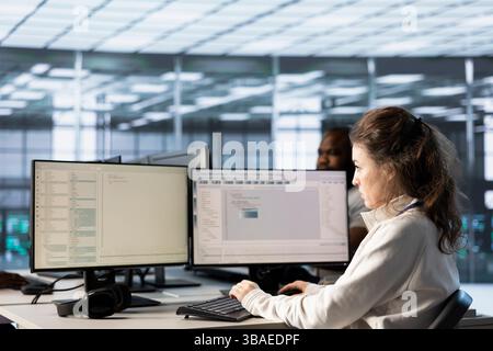 Admins doing yearly checkup to prolong data center electronics life span and avoid downtime. Computer scientists in server room monitoring server infrastructure components Stock Photo