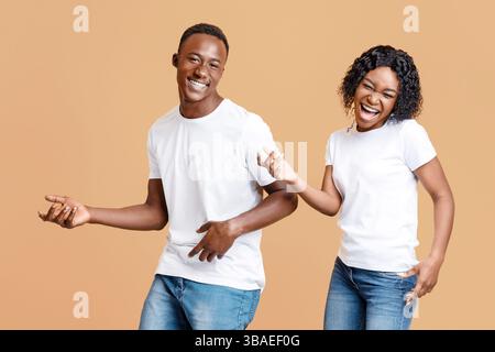 Joyful african american lovers having fun together, moving and screaming Stock Photo