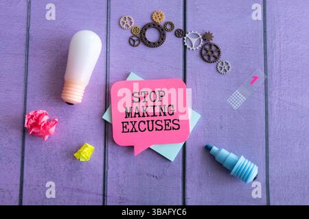Motivational text Stop making excuses on paper on notebook background Stock Photo