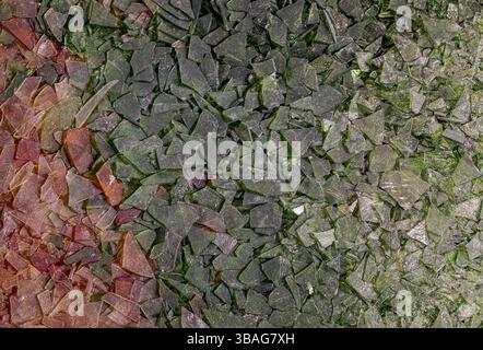 Fragments of transparent and colored plastic sheets, damaged, dirty, ruined and worn. Abstract background. Stock Photo