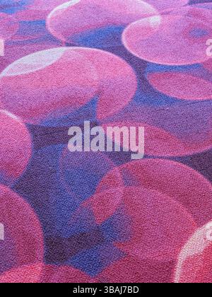 Abstract pattern featuring overlapping circles in shades of pink, purple, and blue with a textured fabric surface. Suitable as a background or design Stock Photo