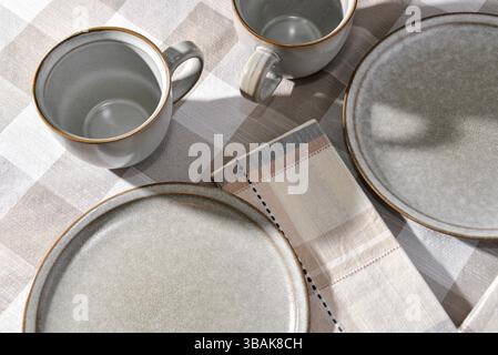 Empty plates and coffee cups on table Stock Photo