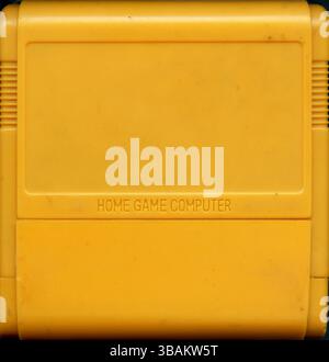 Blank Yellow Famicom Game Cartridge with Embossed HOME GAME COMPUTER Text from 1990s Chinese Console Market Stock Photo