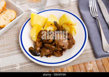 Fried rabbit liver served with boiled potato Stock Photo