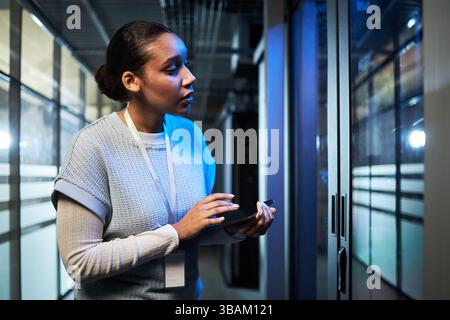 Inspecting Data Center Server Room with Tablet Device Stock Photo