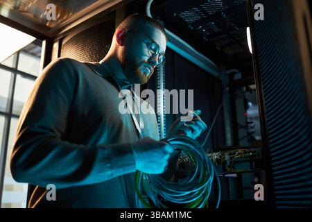 Technician Working Inside Network Server Room Stock Photo