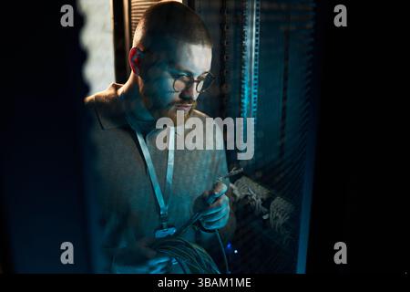 At Work Maintaining Network Cables in Data Center Stock Photo
