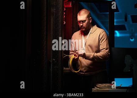 Technician Working Inside Data Center With Network Cables Stock Photo