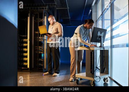 Working in Data Center with Advanced Technology Stock Photo