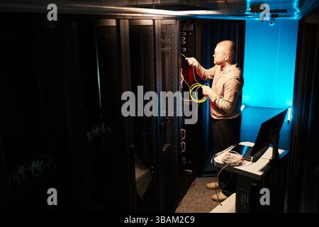 IT Technician Working in High-Tech Data Center Stock Photo