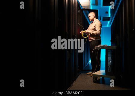 Technician Inspecting Server Racks in Data Center Stock Photo