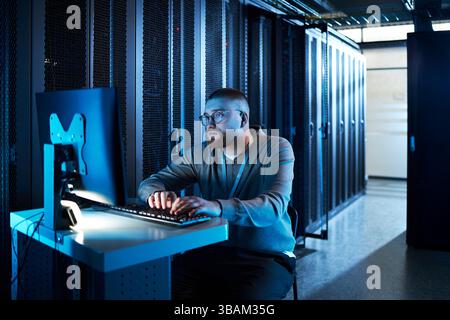 Man Working on Computer in Data Center Stock Photo