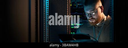 IT Technician Working in Data Server Room Stock Photo
