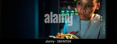 African American Woman Working in Data Center Stock Photo