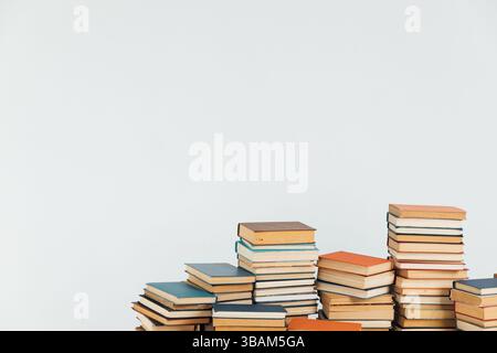 Stacks of old educational books for learning on a white background Stock Photo