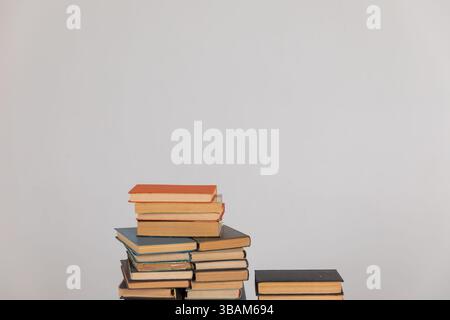 Stacks of old educational books for learning on a white background Stock Photo