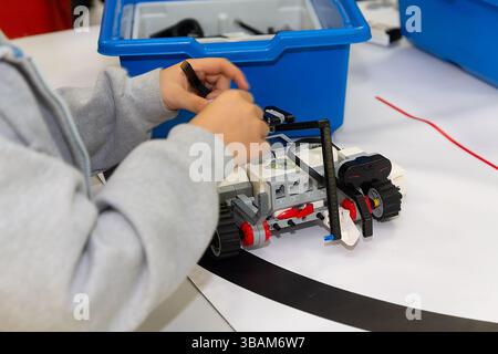 Children are working on model assembly in robotics class. Education Stock Photo