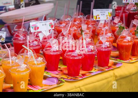 Smoothies served in plastic cups with drinking straws at Brick Lane market, London, UK Stock Photo