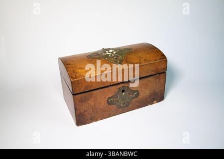 Vintage wooden tea caddy with intricate craftsmanship, isolated on a white background. Perfect for heritage and collectible themes. Stock Photo