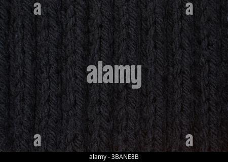 Detailed black wool texture background. Rib stitch knitting pattern. Stock Photo