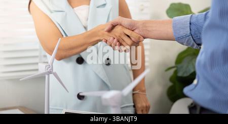 Sustainability partnership: Handshake between two colleagues in an office Stock Photo