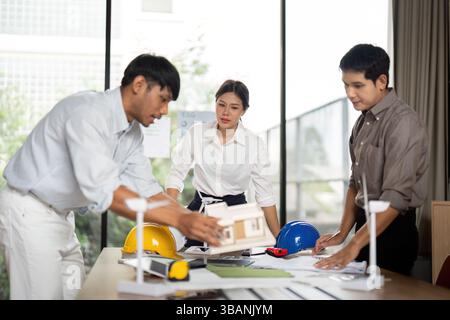 Sustainability in engineering: diverse team collaborating on green architecture Stock Photo
