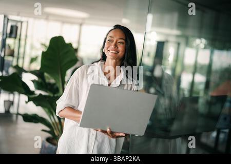 Portrait of a beautiful successful young business people software engineer with laptop in the office Stock Photo