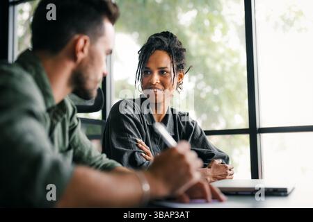 Group of young multi-ethnic startup business team collaborating on project in modern office Stock Photo