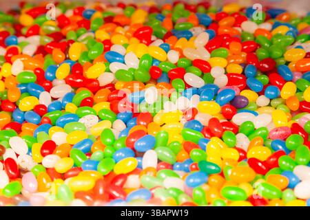 Background from a pile of oval candies in multi-colored glaze. Stock Photo