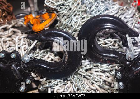 Chain hoists for lifting weights in a workshop close-up. Stock Photo
