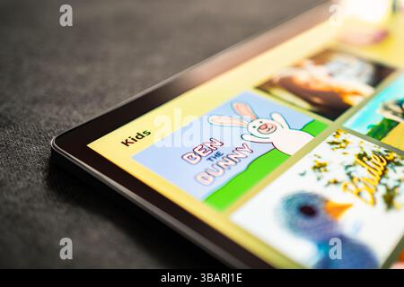 Cartoon videos in tablet for kids. Game or movie for children of family. Animated series for child. Mockup tv stream service. Screen time and internet. Stock Photo