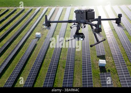 Industrial drone inspects solar panels. Drone is analyzing solar power station Stock Photo