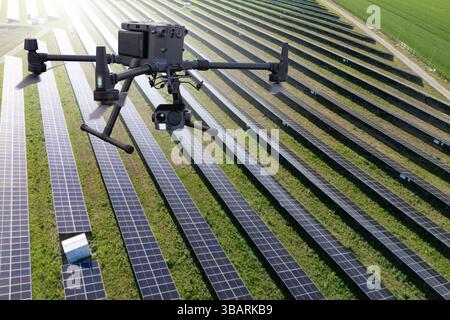 Industrial drone inspects solar panels. Drone is analyzing solar power station Stock Photo