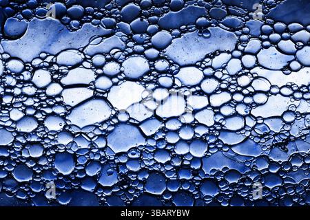 Closeup of abstract foam texture. Blue bubbles pattern with shiny gel effect. Clean surface with macro soap froth. Skincare and cosmetic concept. Stock Photo