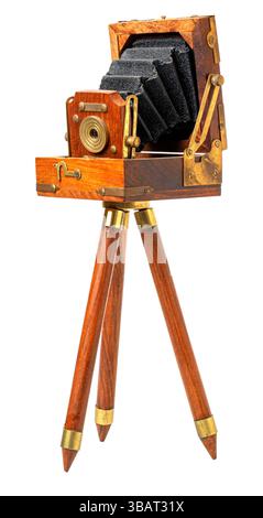 Antique wooden folding camera standing on a tripod, showcasing the history of photography Stock Photo