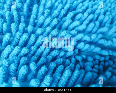 Abstract closeup of a textured blue microfiber cloth or mat. Soft, absorbent material for cleaning, bath, or home decor. Illustrates comfort, hygiene, Stock Photo