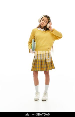 schoolgirl girl stands with books in the classroom Stock Photo - Alamy
