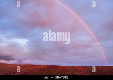 Rainbow and Dramatic clouds over Coomanaspig Pass near Portmagee, County Kerry, Ireland Stock Photo