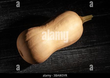 butternut on black wood background top view Stock Photo