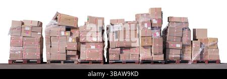 Multiple Packages Piled-up On Wooden Palettes At A Distribution Hub, Isolated On A White Background Stock Photo