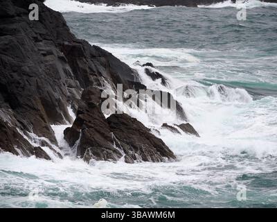 Waves breaking on cliff, Scolpaig, North Uist, Outer Hebrides, Scotland Stock Photo