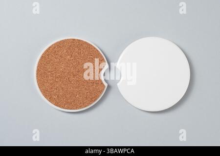 Two car cup holder coasters. Top view of ceramic coaters on isolated background. Blank coasters with cork basis mockup Stock Photo