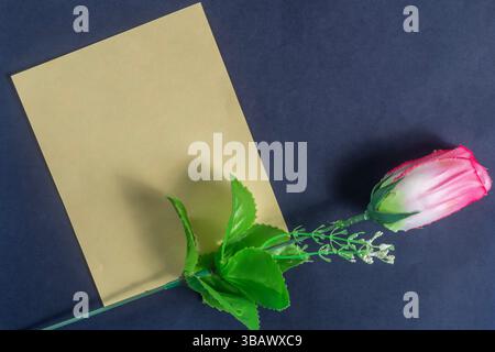 Single red rose in a yellow cardboard box on a dark background. Valentine's Day. Stock Photo
